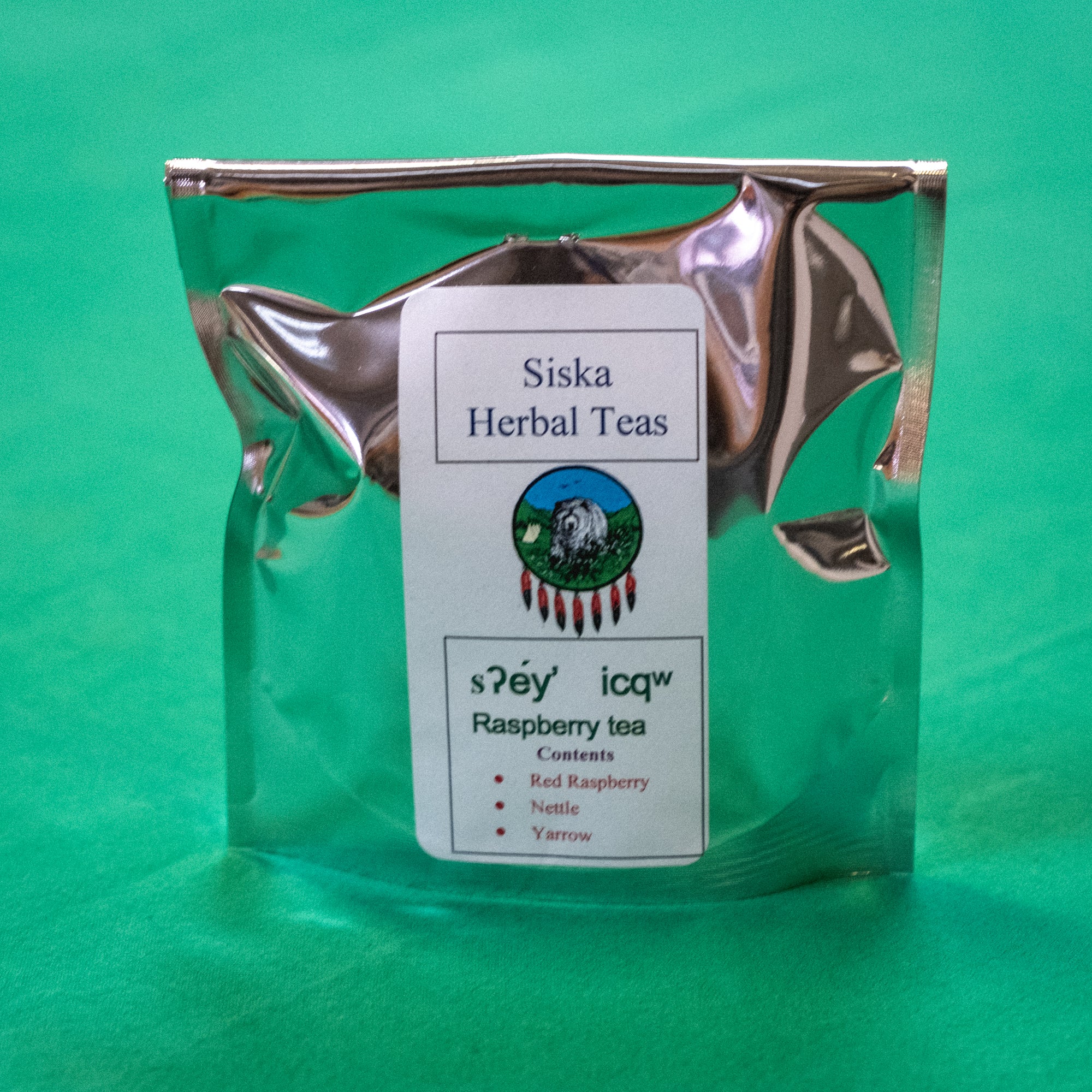 A bag of tea with a label that says "Siska Herbal Teas. Raspberry tea. Contents red raspberry, nettle, yarrow." End of image description.