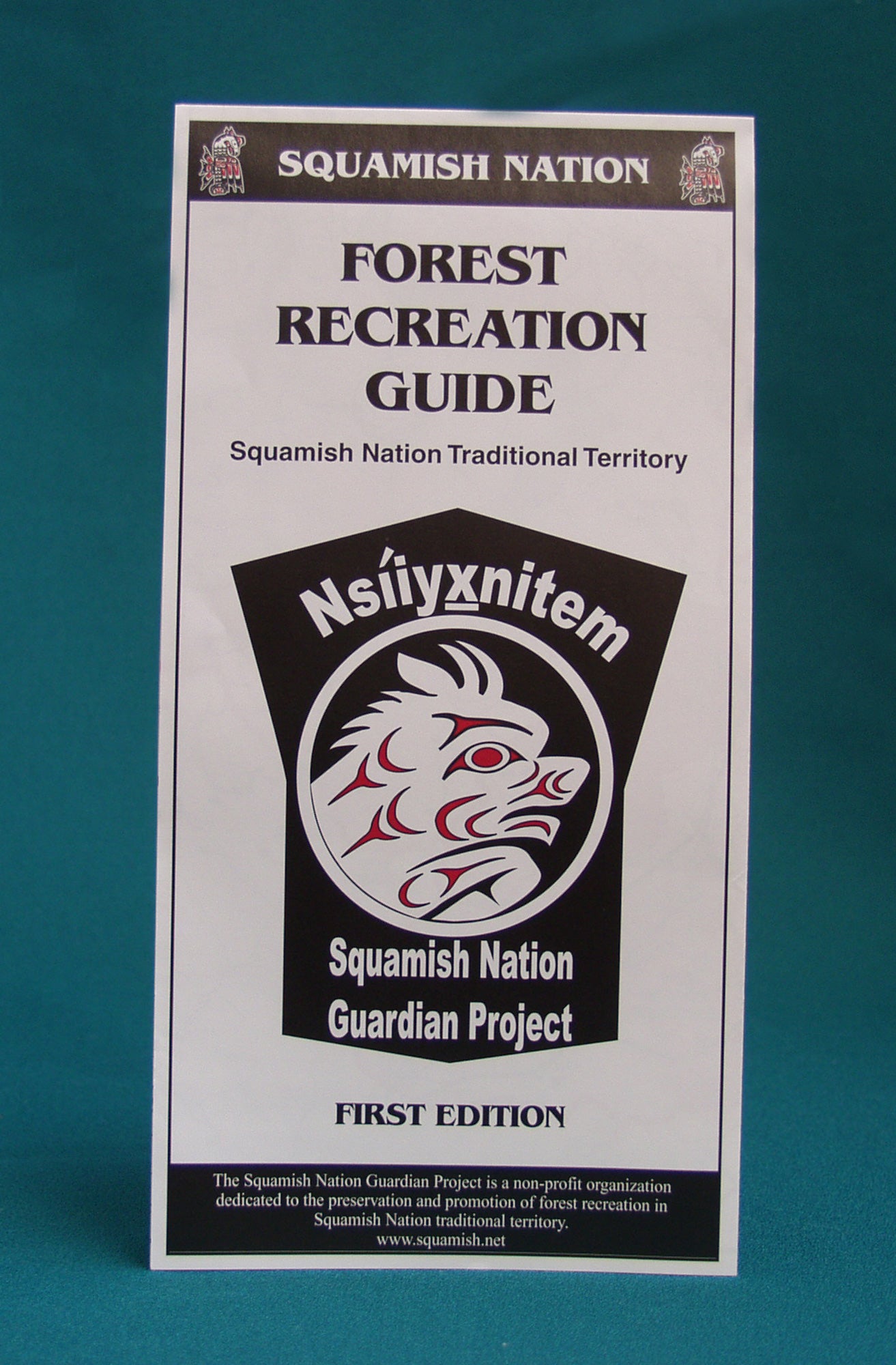 A pamphlet that says "Squamish Nation. Forest Recreation Guide. Squamish Nation Traditional Territory. Squamish Nation guardian project. First edition." End of image description. 