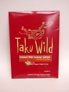A packet with illustrations of salmon. Text on the image says "Taku Wild. Smoked Wild Sockeye Salmon from the Taku River. Smoked with Organic Maple Syrup." End of image description.