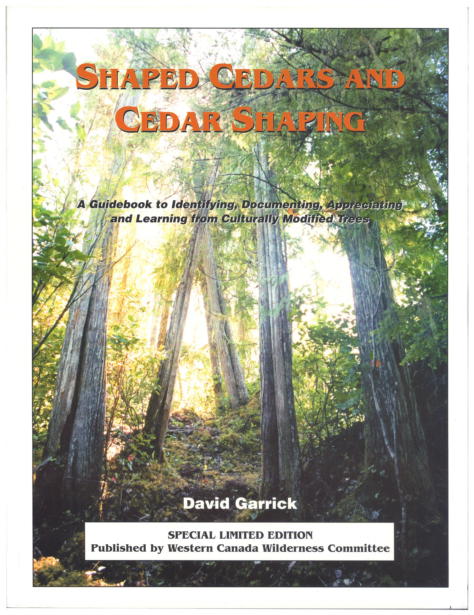 Old-growth trees in a forest. Text over the image says "Shaped Cedars and Cedar Shaping. A guidebook to identifying, documenting, appreciating and learning from culturally modified trees. David Garrick. Special limited edition. Published by Western Canada Wilderness Committee." End of image description. 