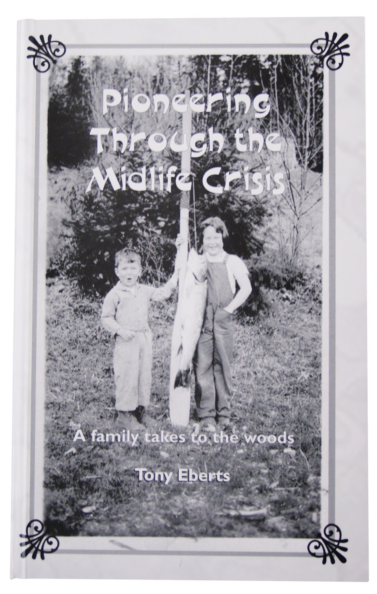 A photo of two children standing next to a tree. Text over the image says "Pioneering Through the Midlife Crisis. A family takes to the woods. Tony Eberts." End of image description.