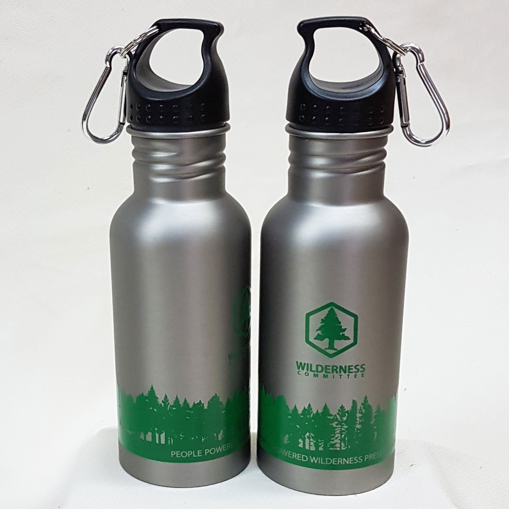 Two reusable tin water bottles with the Wilderness Committee logo. End of image description,